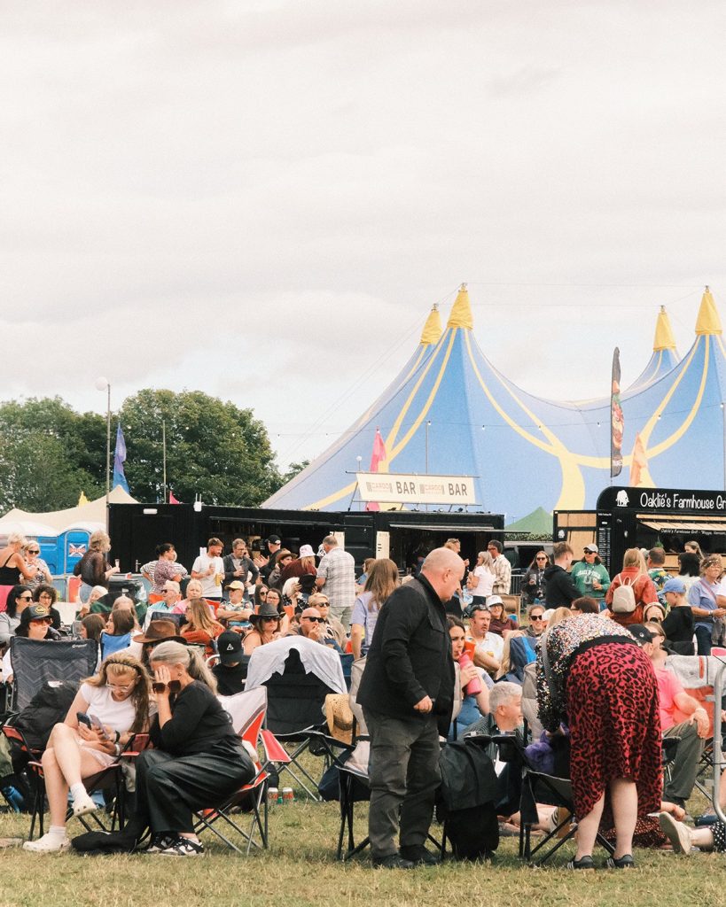 The crowd seated in front of the big top