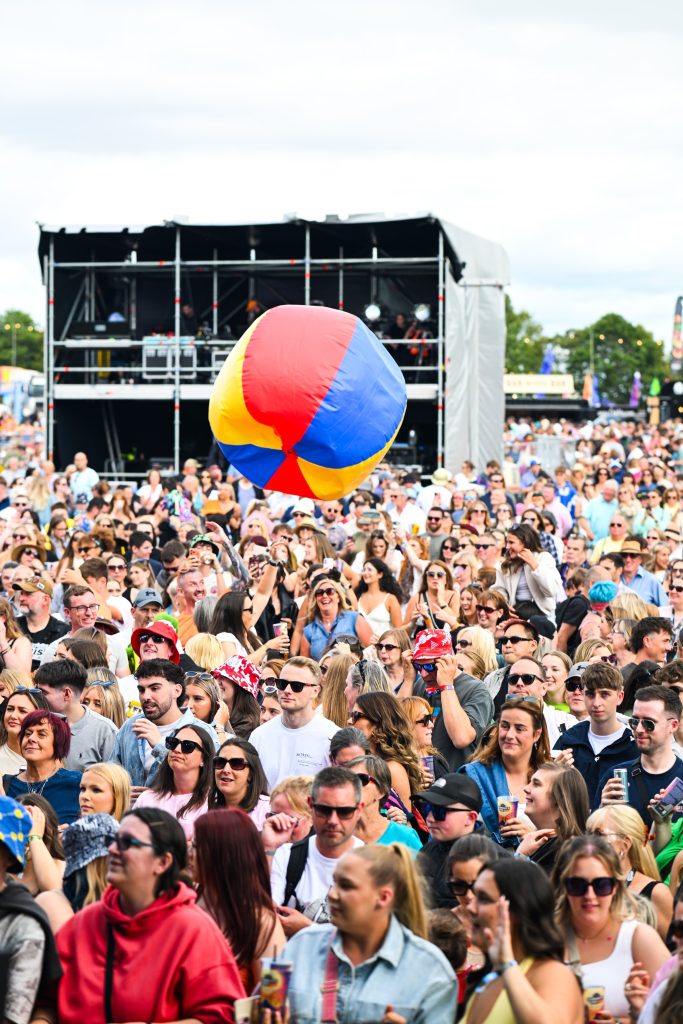 A beach ball bouncing over the crowd at the main stage