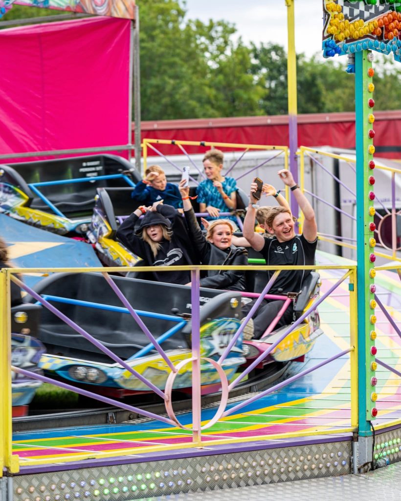 The waltzer painted in yellow, pink and blue